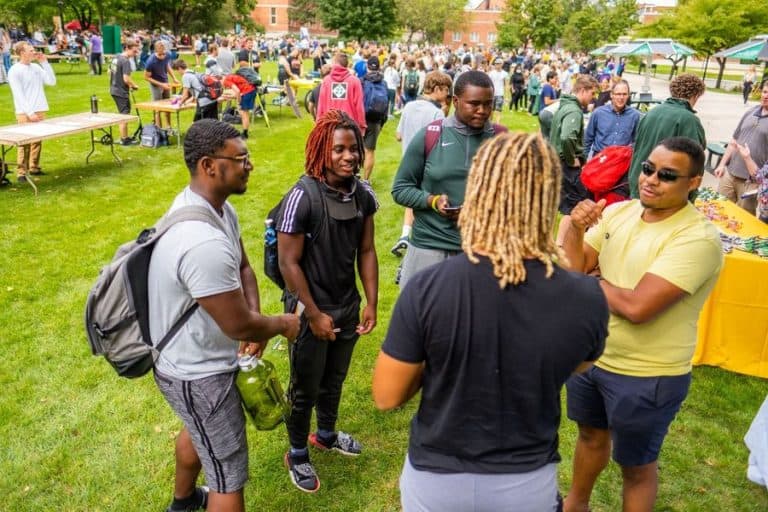 A group of SNC students talking at a on campus event